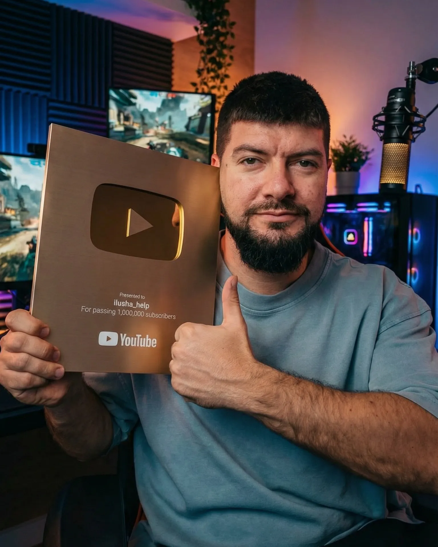 Kostiantyn Yakymenko holding the YouTube Gold Creator Award for passing 1,000,000 subscribers